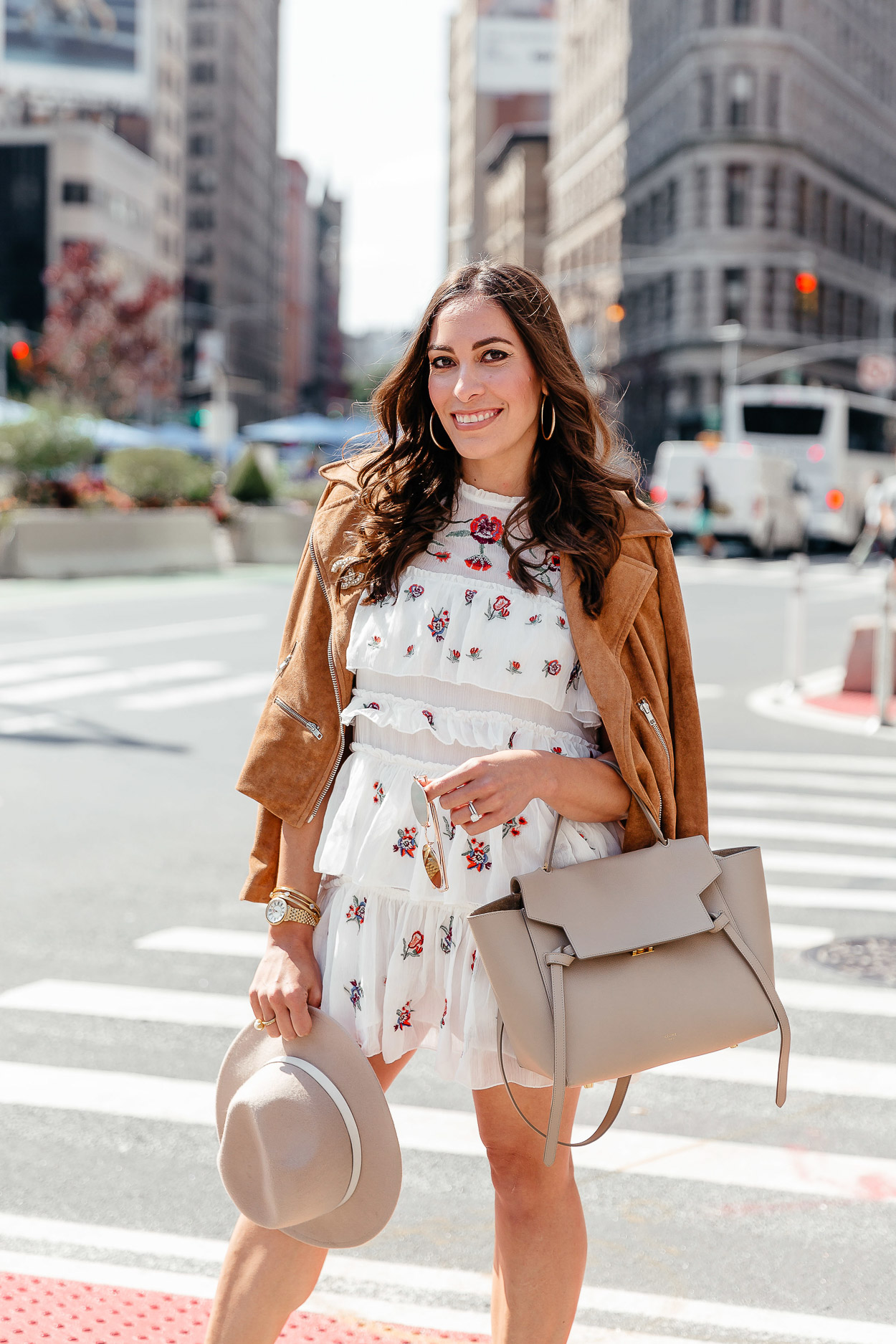 A Glam Lifestyle blogger wears Chicwish tiered floral dress with white booties and Celine belt bag