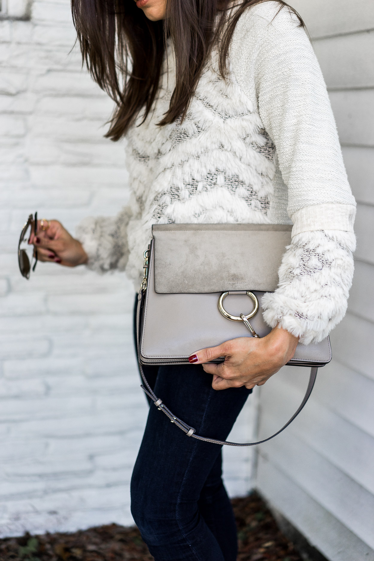 woman showing her Chloe Faye bag 