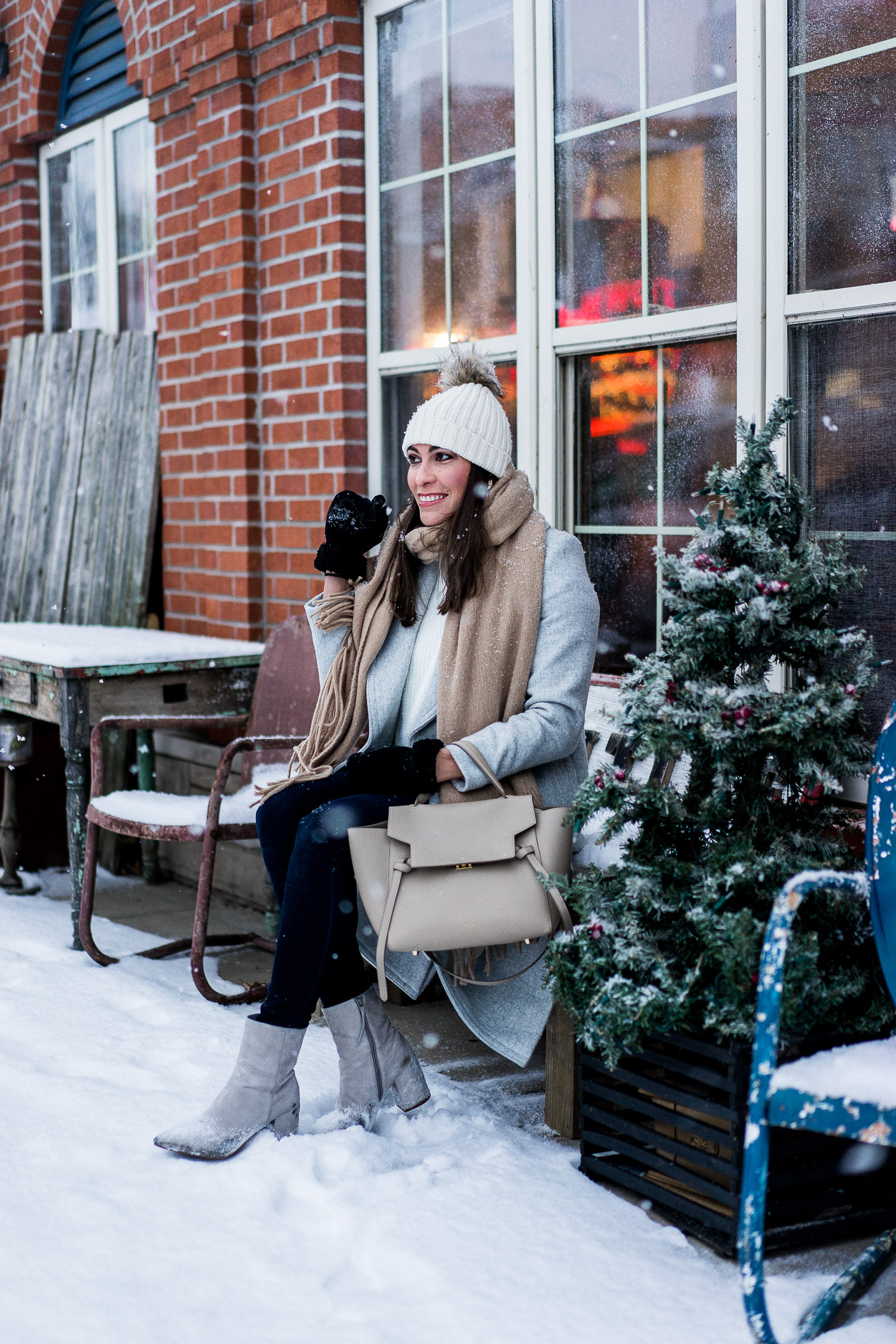 Amanda of A Glam Lifestyle sitting outside the snow