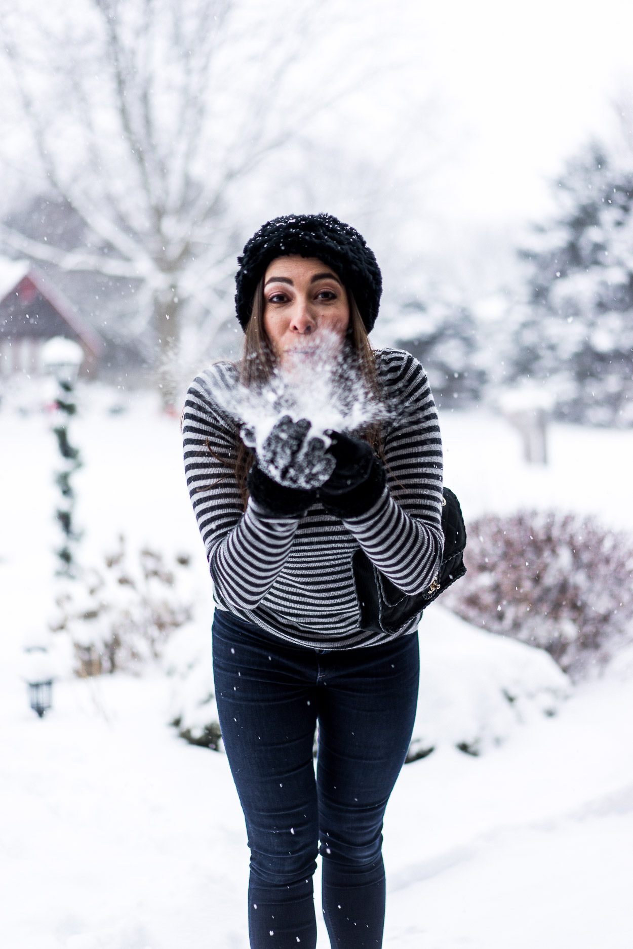 Amanda blowing snow from her hands