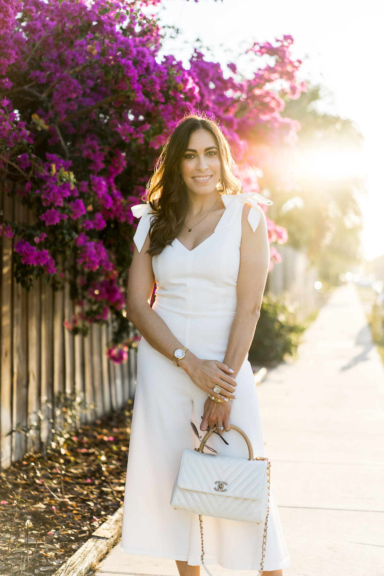 Cece white jumpsuit and Chanel bag