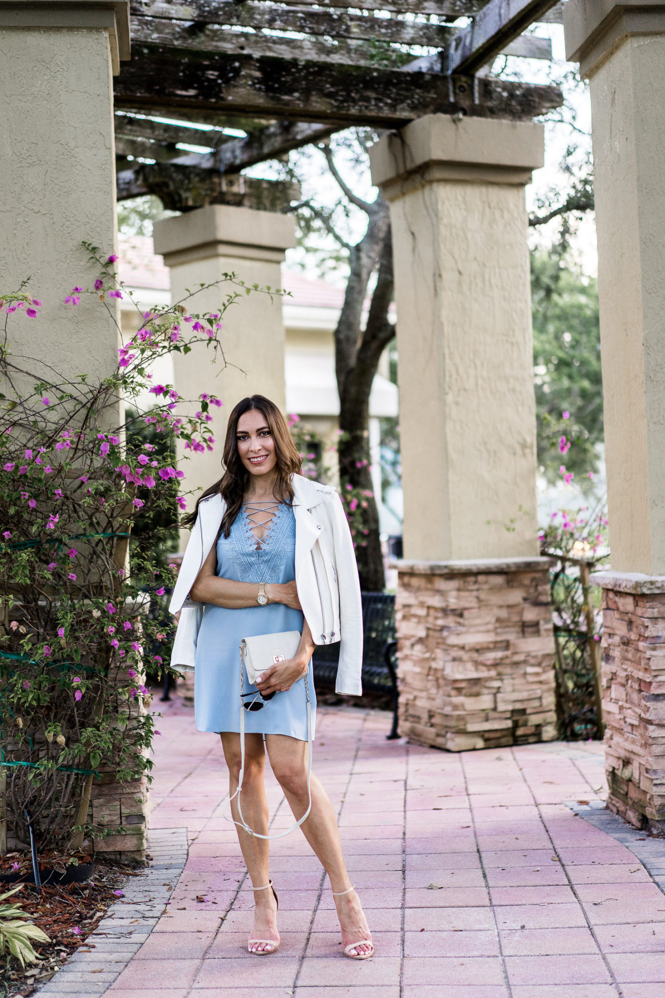 white leather jacket over blue lace up dress