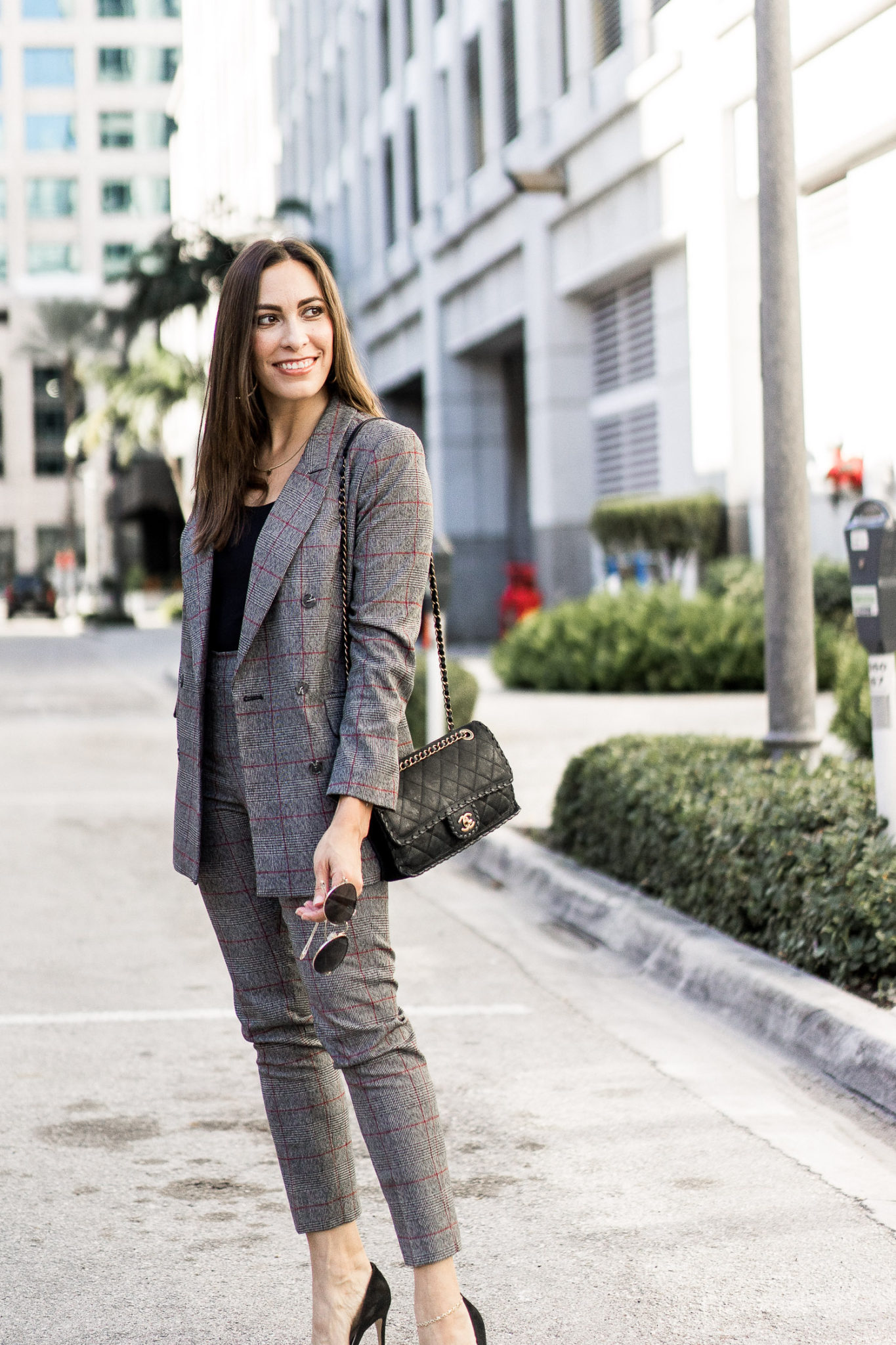 a plaid suit by Cece at Nordstrom with her Hanky Panky bodysuit and chic Chanel bag