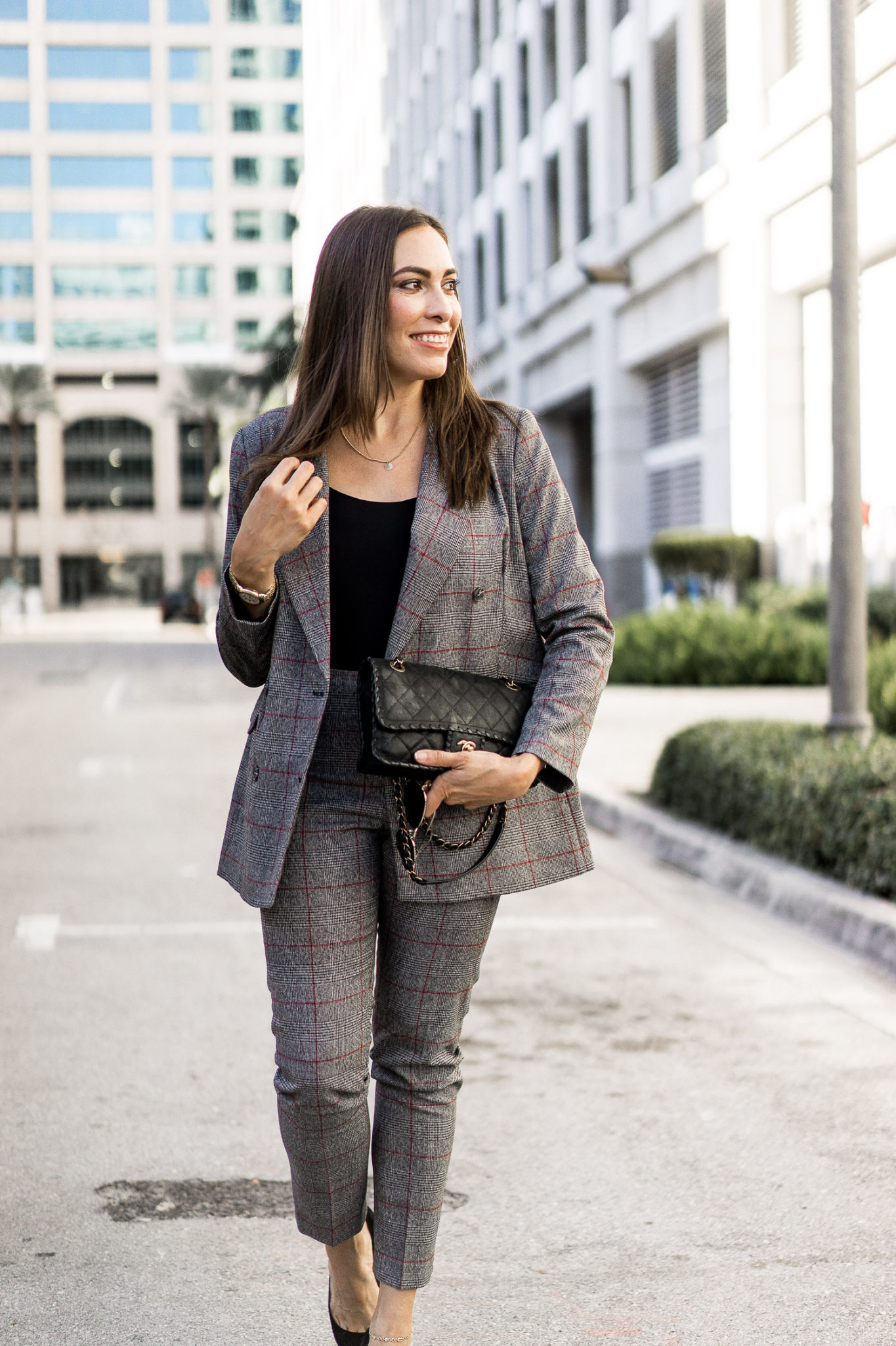 Amanda layers her plaid power suit with a classic bare body suit by Hanky Panky