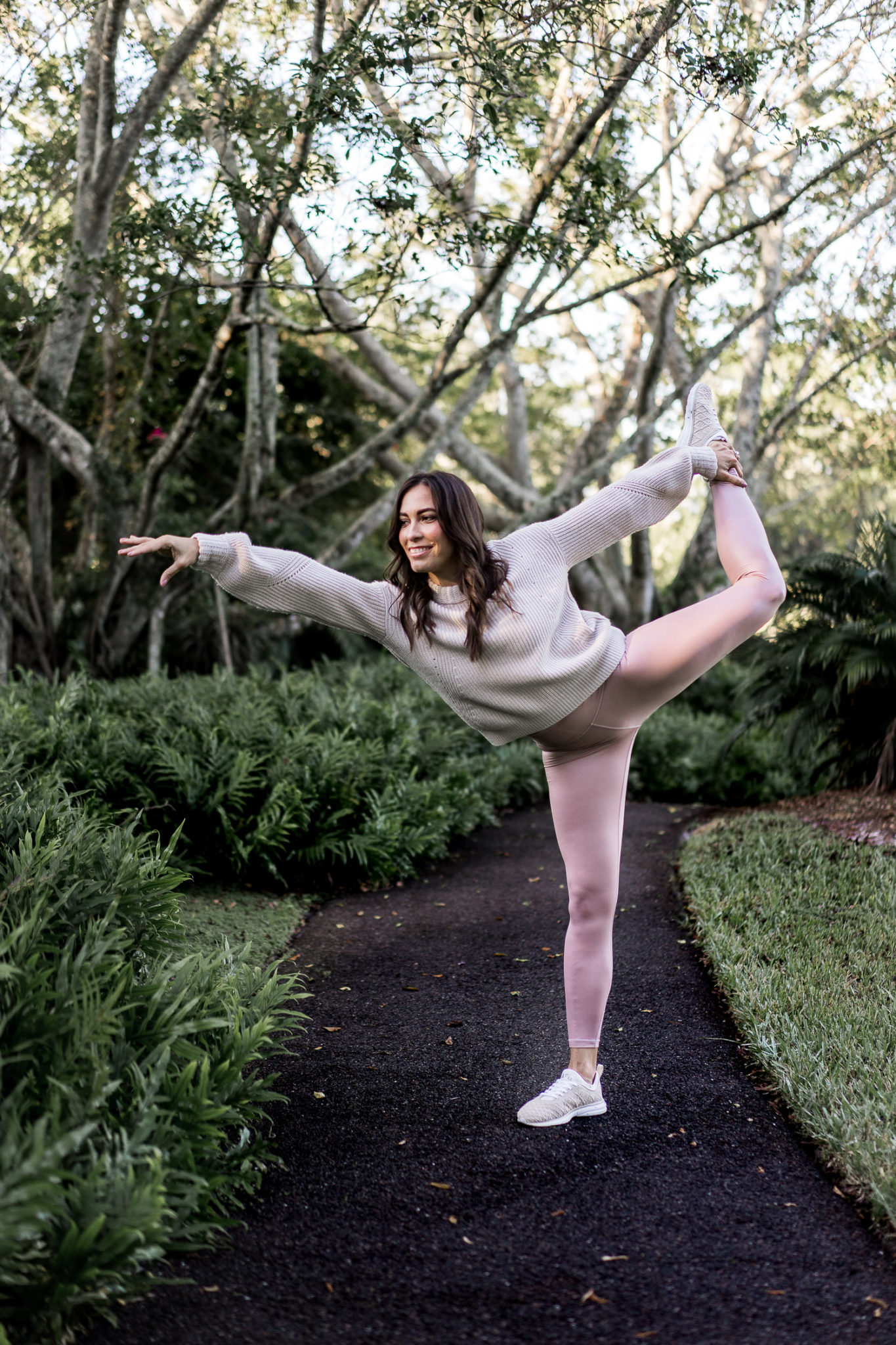 Amanda rocks her Athleta leggings while doing yoga in the park