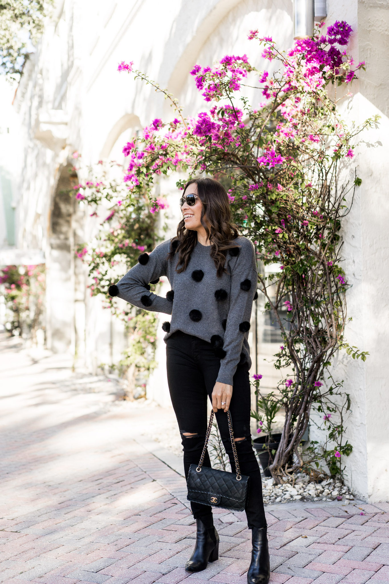 Amanda wears a cute pom pom sweater by Cece at Nordstrom with her go-go Mother denim and classic Chanel bag