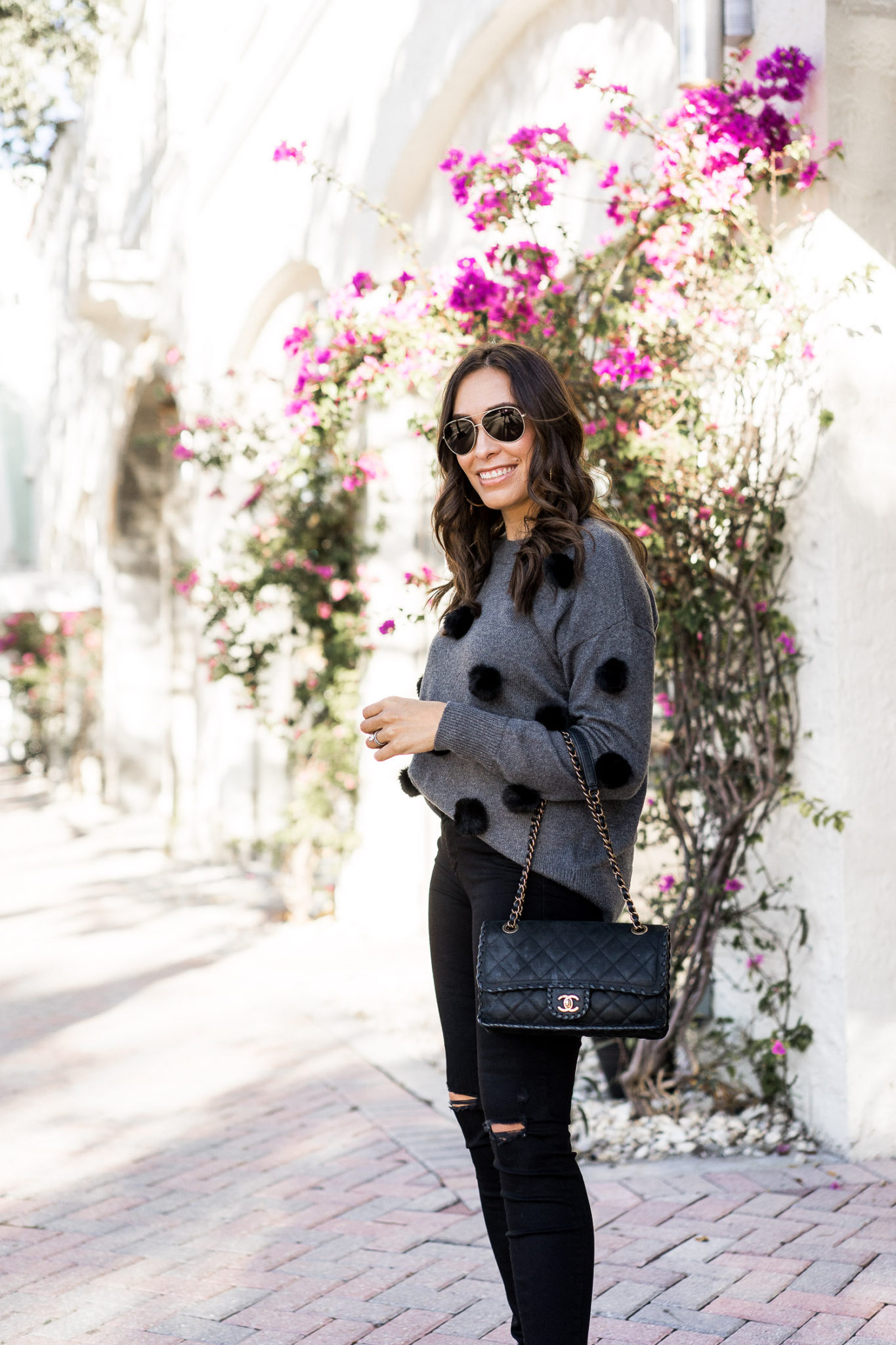 Amanda wears the pom pom sweater by Cece at Nordstrom during a colder day in South Florida