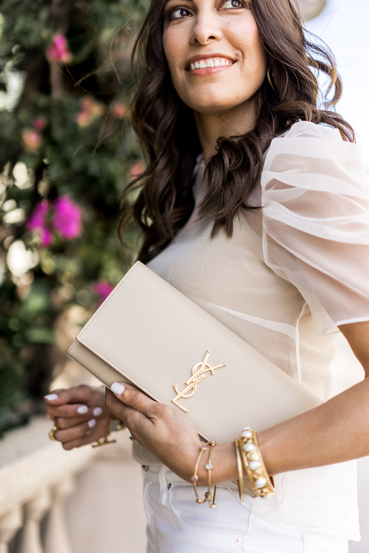 Pair your sheer blouse with the YSL monogram clutch in the nude color for a feminine look