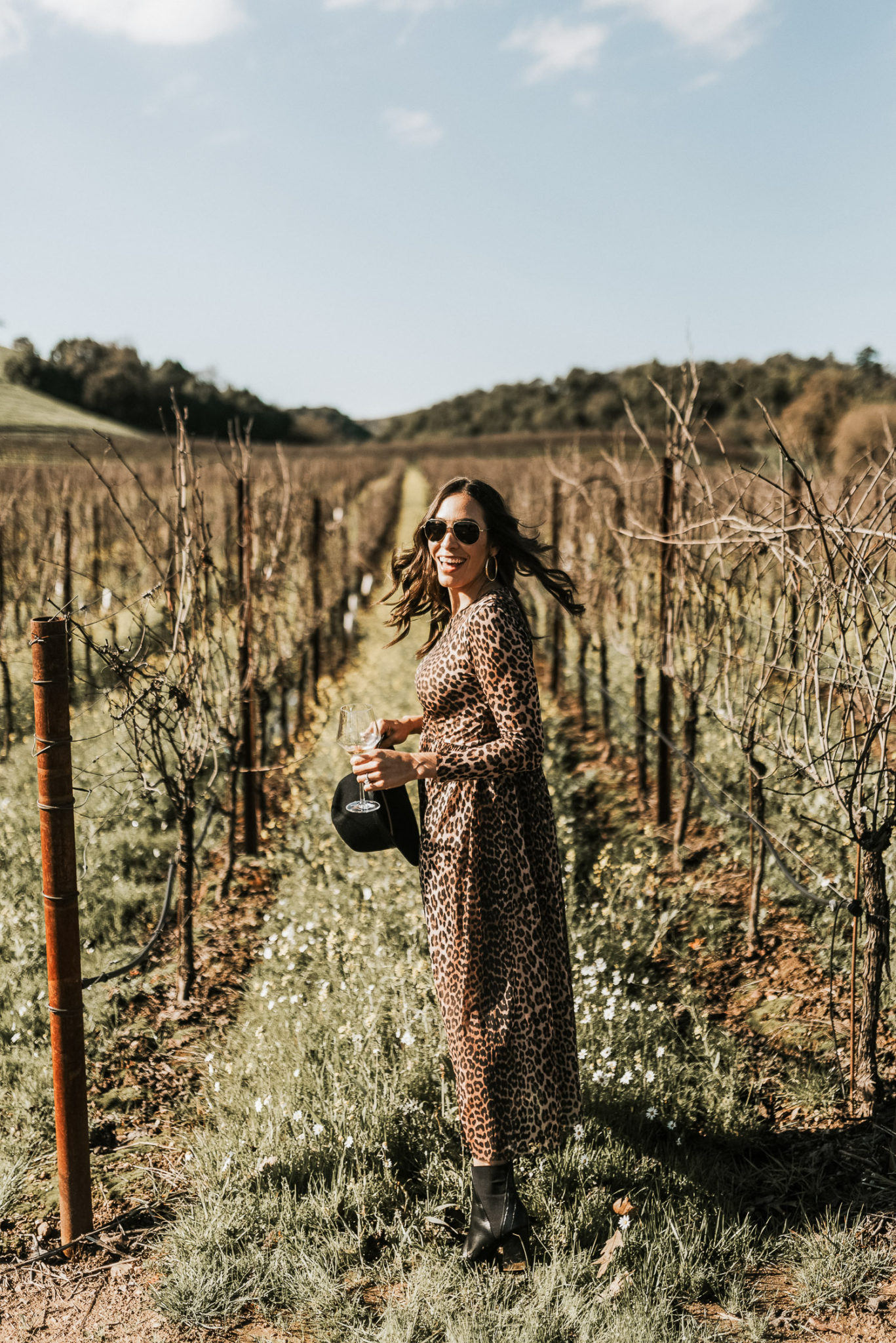 Amanda of A Glam Lifestyle blog wears the Ganni leopard dress at MacRostie Winery in Sonoma