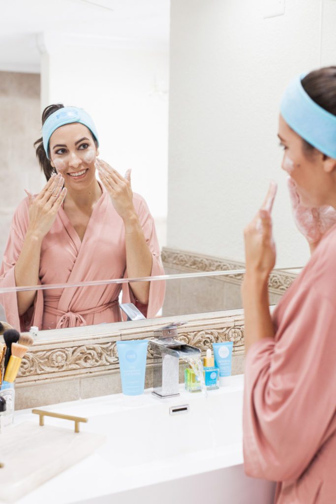 woman using Esmi Skin Minerals on her face