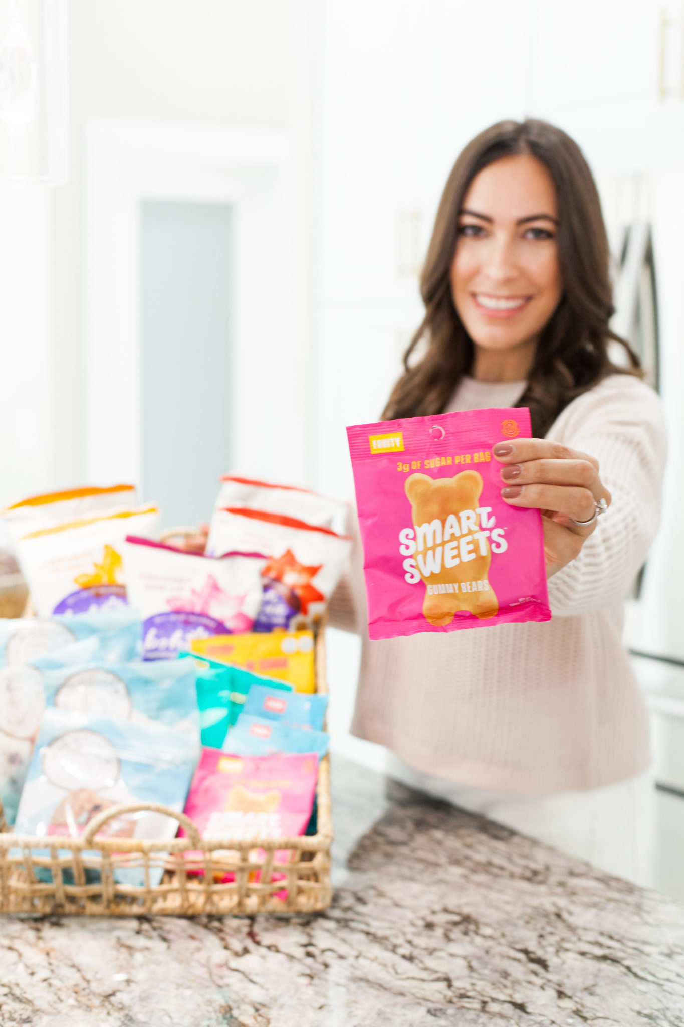 woman holding a bag of Smart Sweets