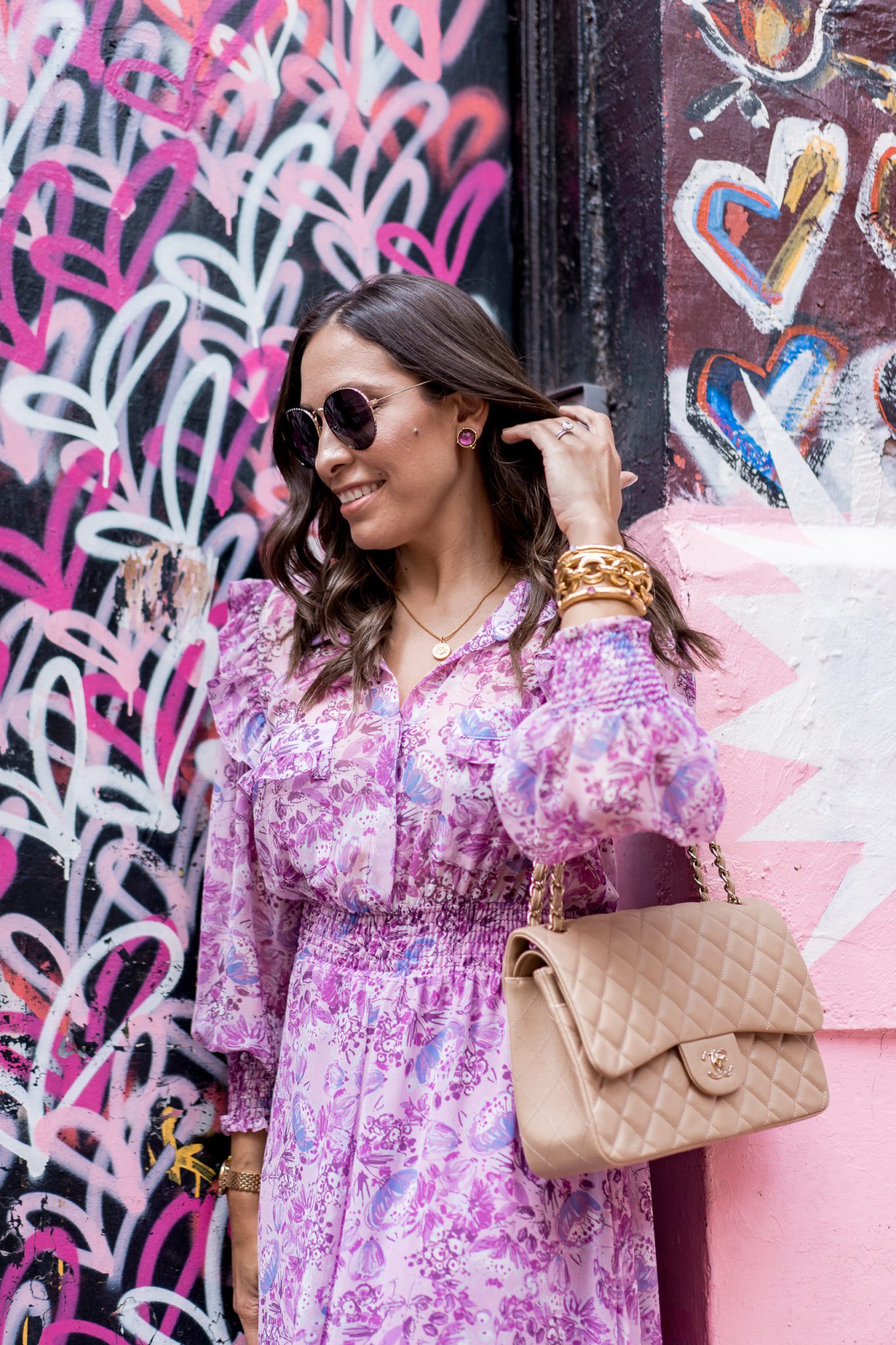 Julie Vos Favorites by popular Florida fashion blog, A Glam Lifestyle: image of a woman standing by a heart wall mural and wearing a purple dress, Julie Vos Catalina Hinge Bangle and Julie Vos Savannah Demi Link Bracelet.