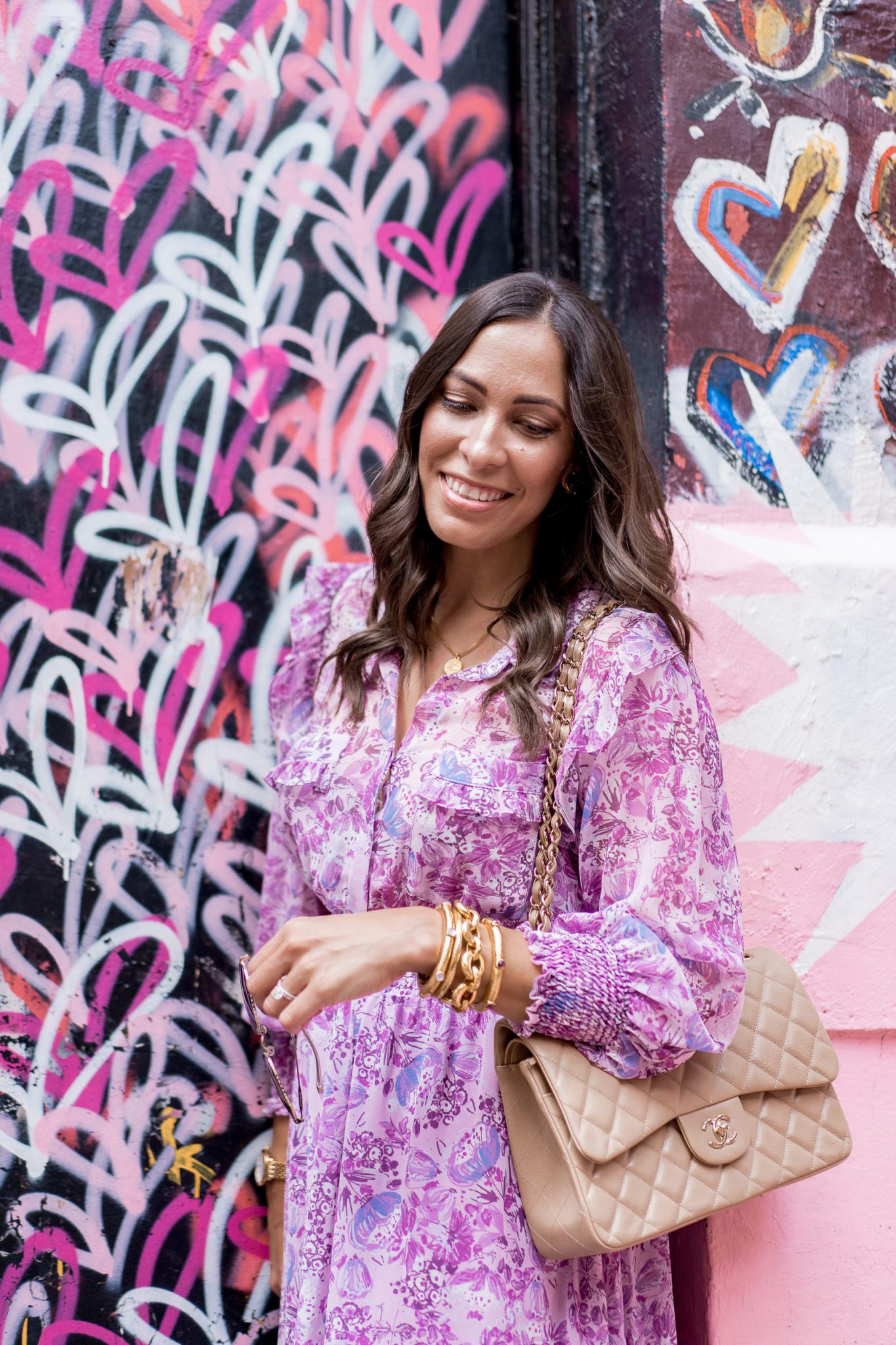 Julie Vos Favorites by popular Florida fashion blog, A Glam Lifestyle: image of a woman standing by a heart wall mural and wearing a purple dress, Julie Vos Catalina Hinge Bangle and Julie Vos Savannah Demi Link Bracelet.