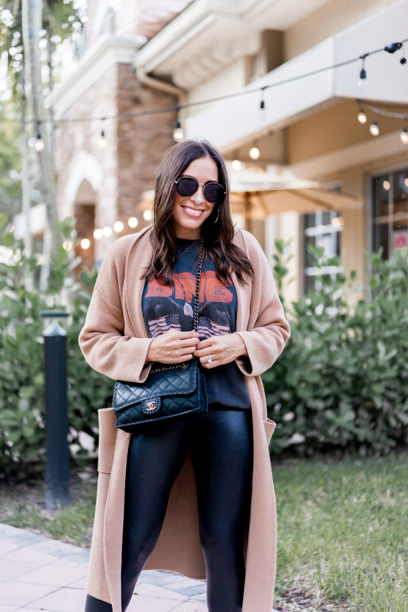 Top Florida fashion blogger Amanda of A Glam Lifestyle wears an Anine Bing sweatshirt paired with Commando faux leather leggings for an easy fall outfit