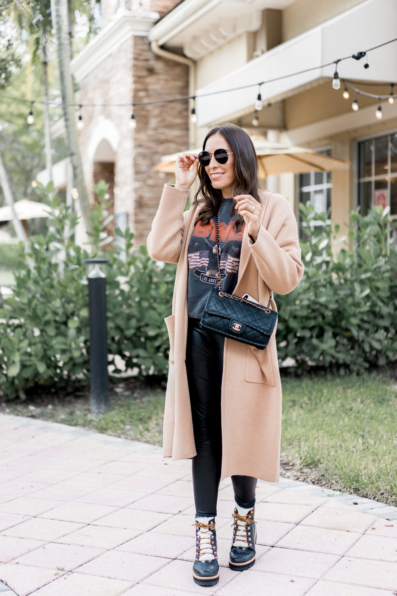 Top Florida fashion blogger Amanda of A Glam Lifestyle wears an Anine Bing sweatshirt paired with Commando faux leather leggings for an easy fall outfit