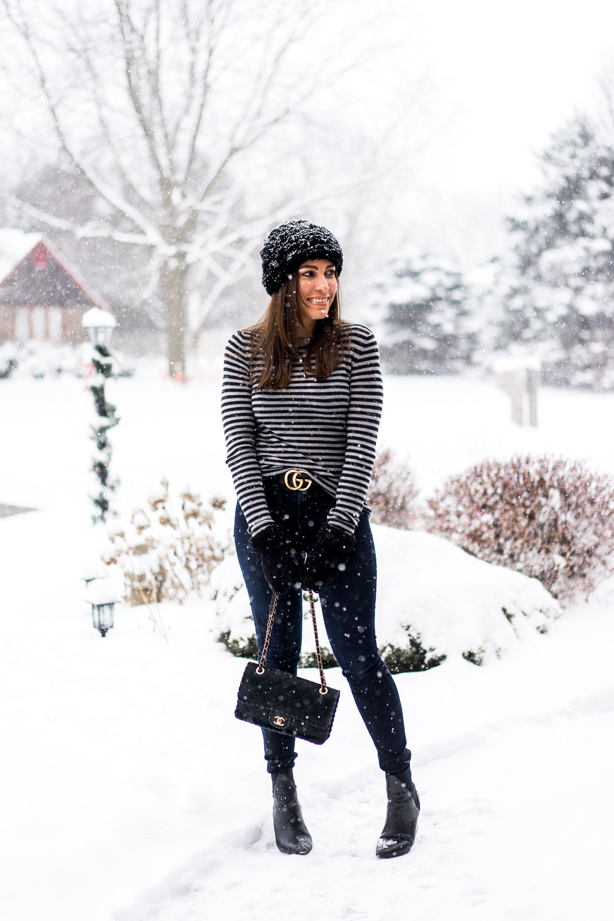 Chanel bag outfit ideas wearing sweater, jeans, and boots