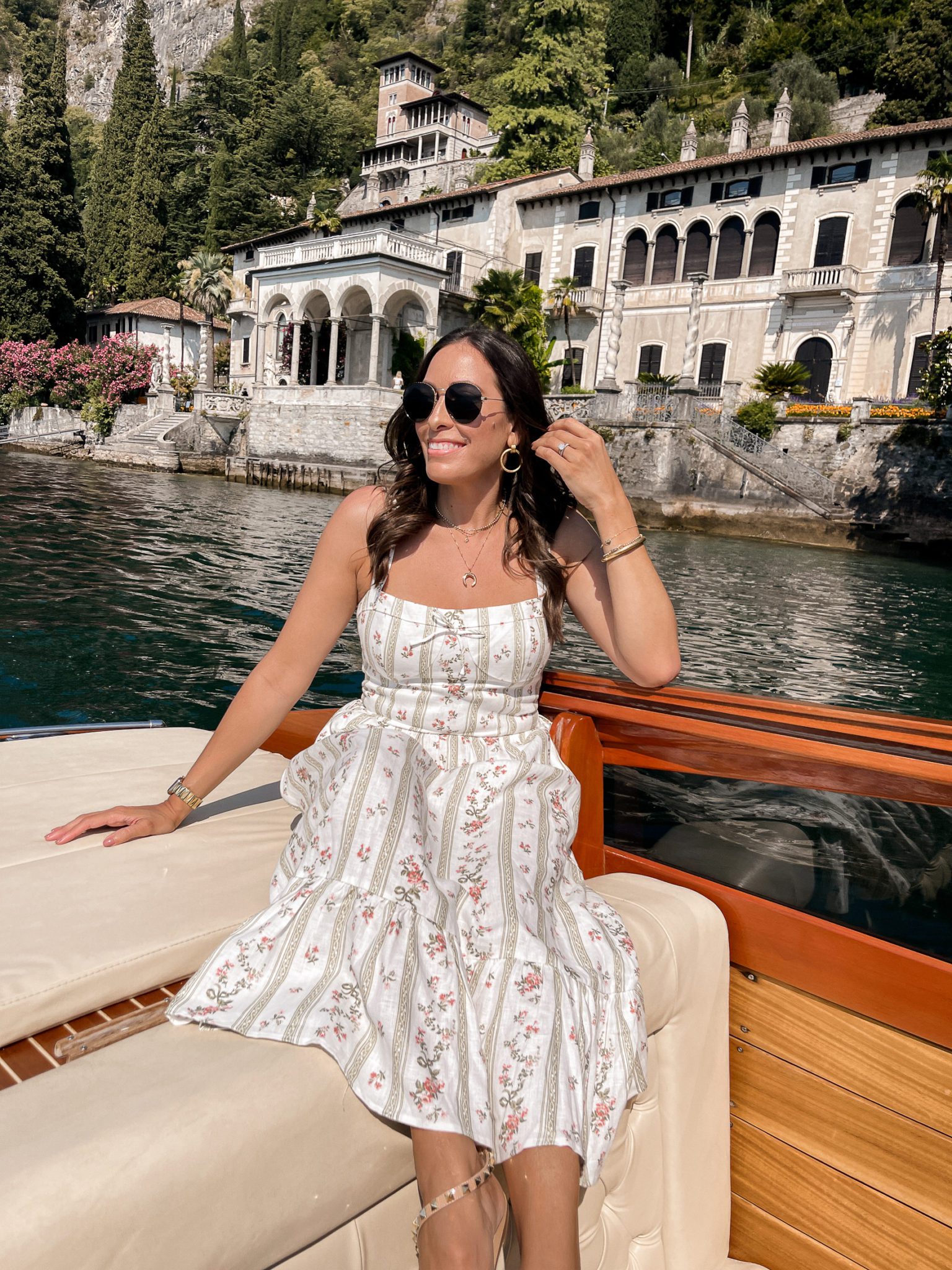 woman riding a boat for Lake Como travel guide