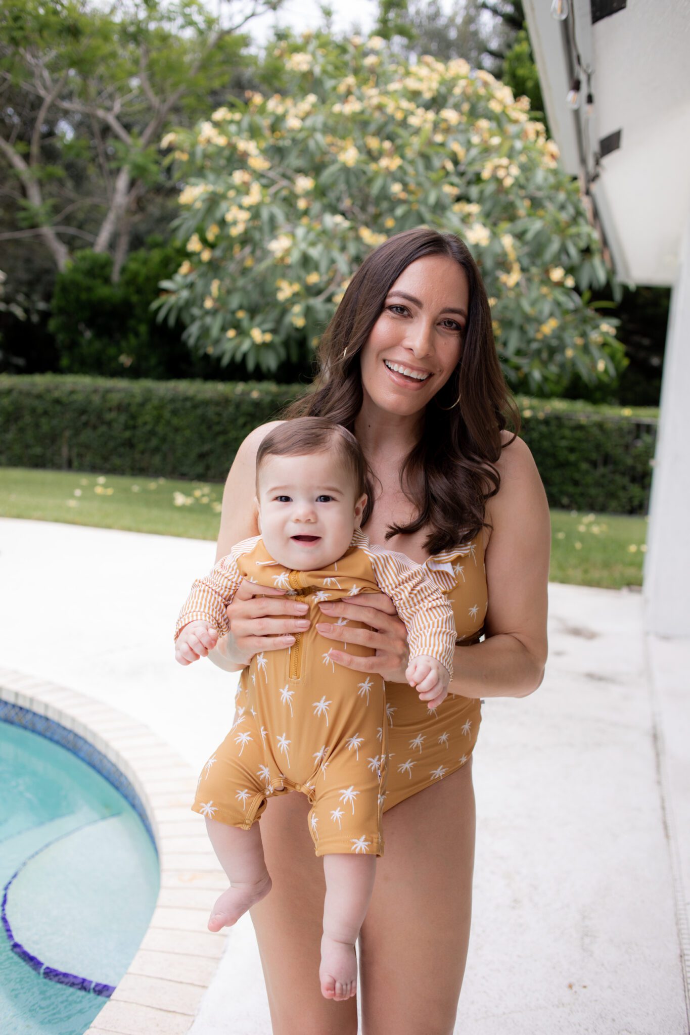 mom and kid wearing matching family swimsuits