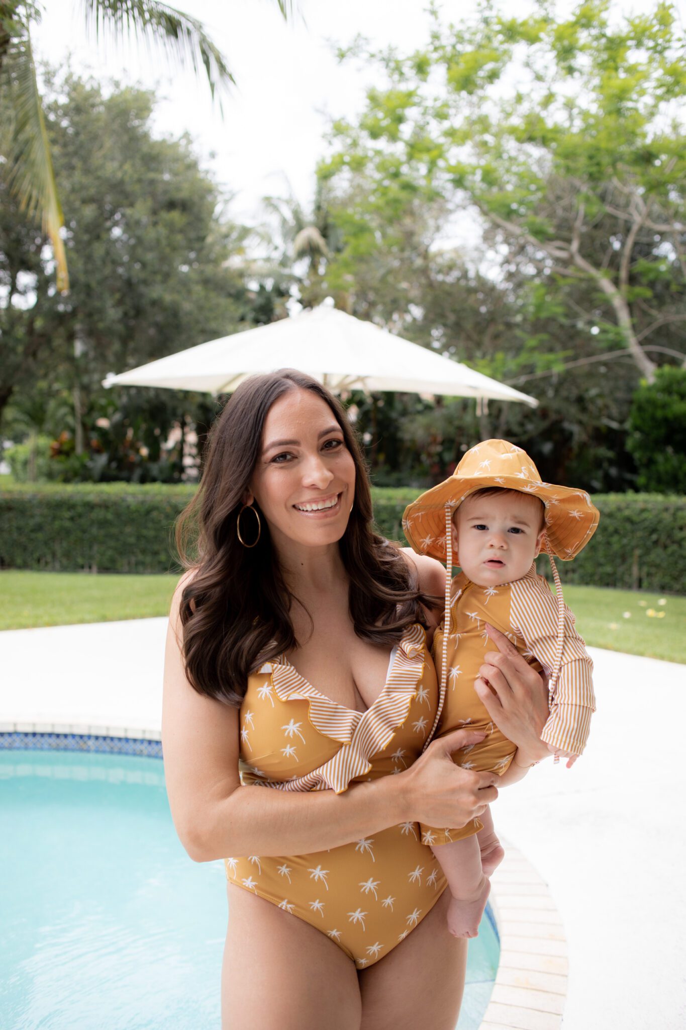 mom and kid matching family swimsuits at the pool