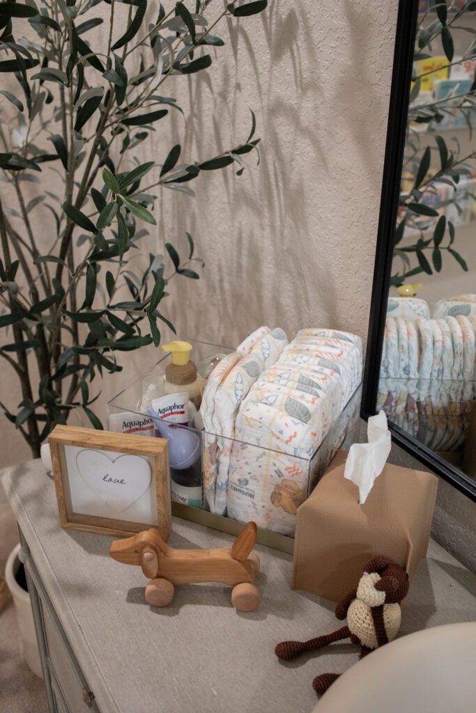 feeding and changing are in a baby boy nursery 