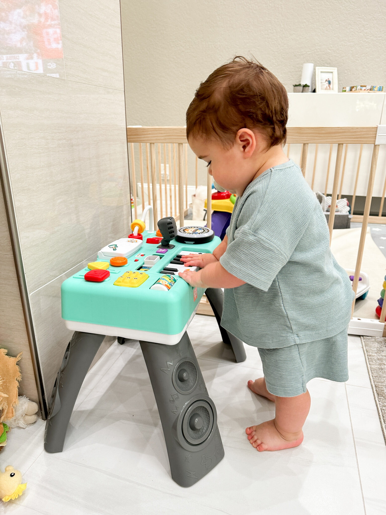 baby playing with a toy for Holiday Gifts for Babies